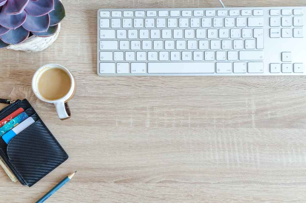 white apple keyboard near white cup